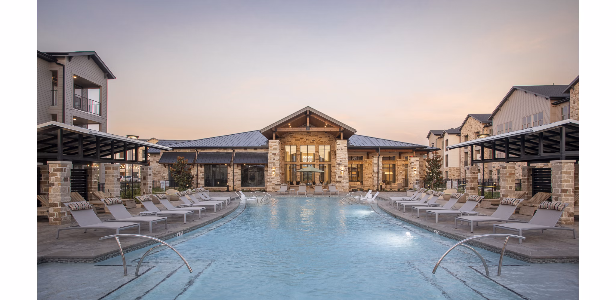 Resort-style pool at Broadstone Cross Creek Ranch Apartments featuring loungers and lush landscaping