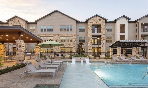 Resort-style pool with lounge chairs at Broadstone Cross Creek Ranch Apartments