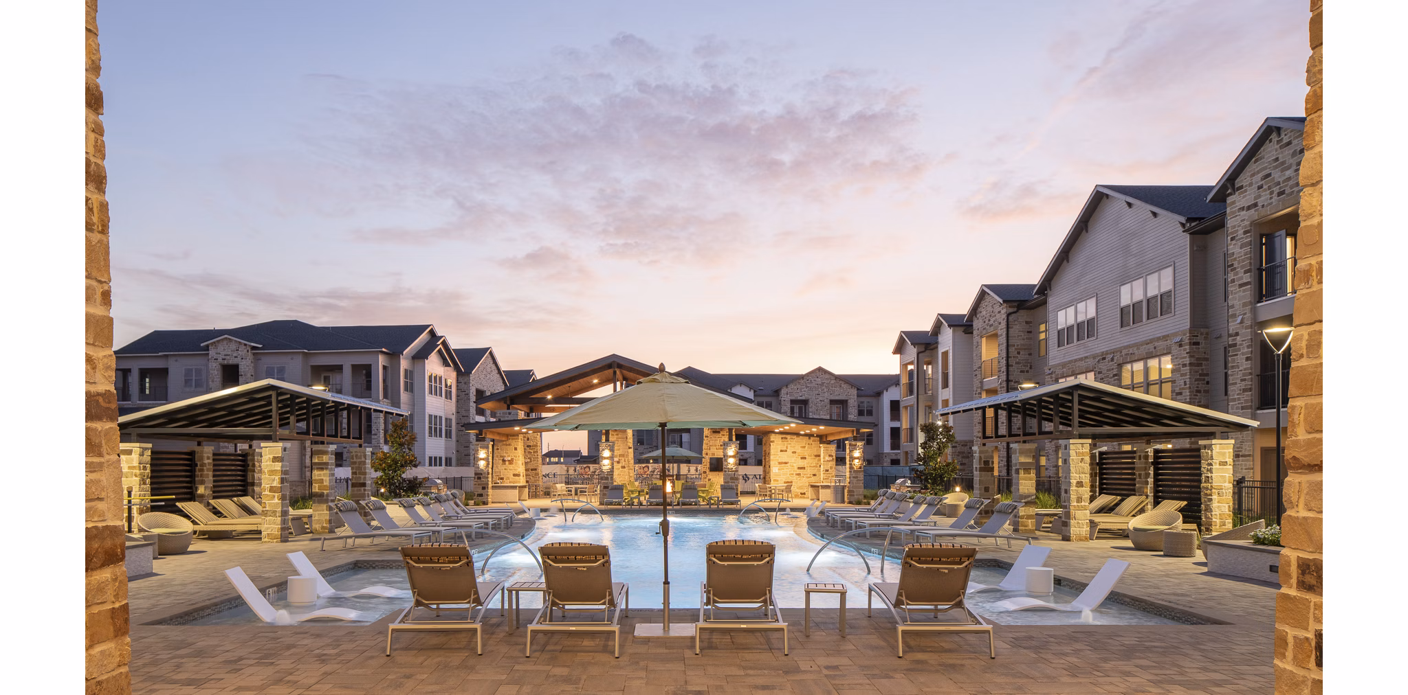 Tranquil outdoor pool at Broadstone Cross Creek Ranch Apartments featuring lounge chairs, surrounded by lush greenery perfect for relaxation