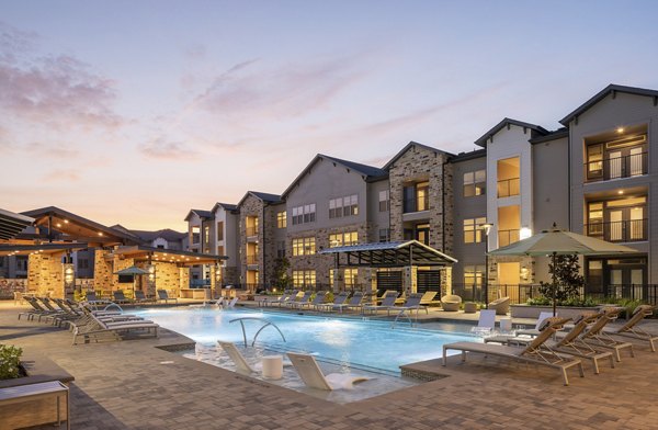 Expansive pool with sun loungers at Broadstone Cross Creek Ranch Apartments, offering luxury amenities and relaxation space for residents