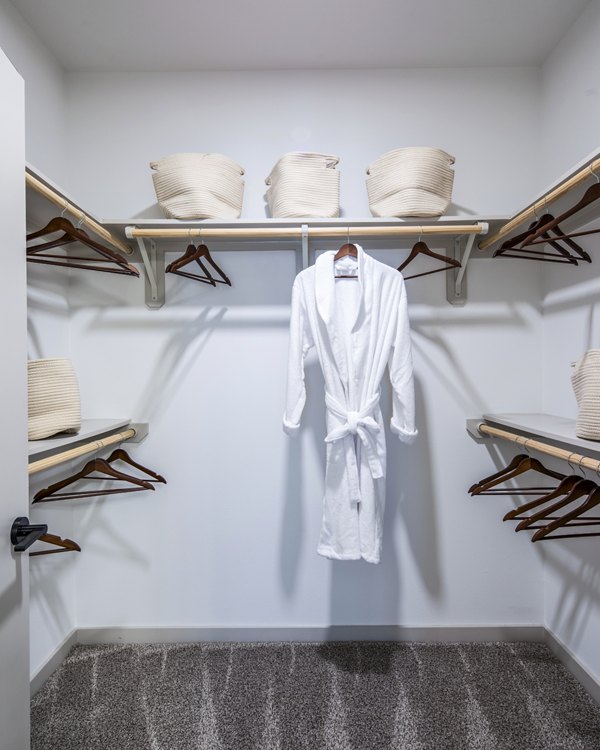 Walk-in bedroom closet with ample shelving at Broadstone Jordan Ranch Apartments, offering luxury living spaces in a vibrant community