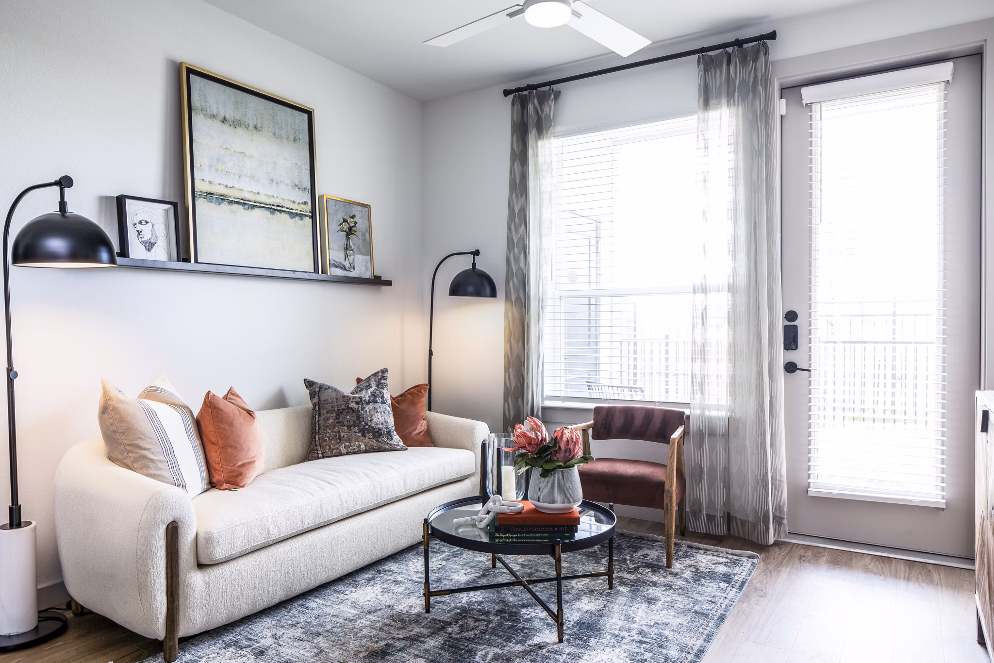 Spacious living room with modern decor and large windows at Broadstone Jordan Ranch Apartments