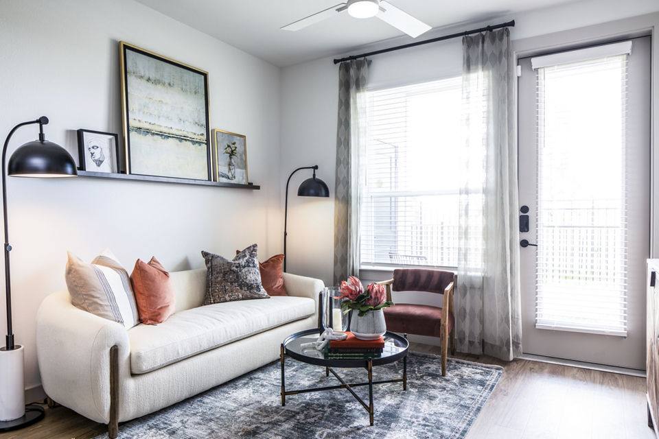 Spacious living room with modern decor and large windows at Broadstone Jordan Ranch Apartments