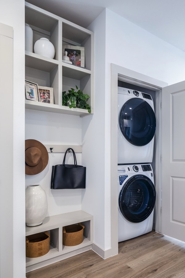 Laundry room featuring modern appliances at Broadstone Jordan Ranch Apartments