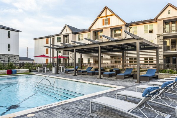 Outdoor swimming pool with lounge chairs and pergola in luxury apartments
