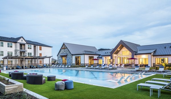 Luxury apartments with a swimming pool and outdoor lounge areas in a modern residential complex