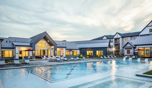 Resort-style swimming pool with lounge chairs at luxury apartments in the community