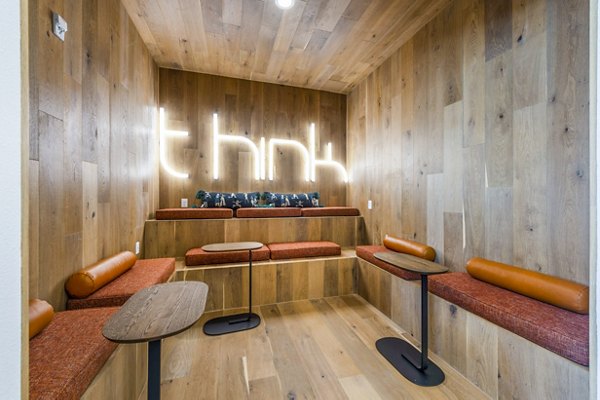 Clubhouse meeting facility with modern seating and large conference table at Lenox Grand West Apartments, perfect for gatherings and events
