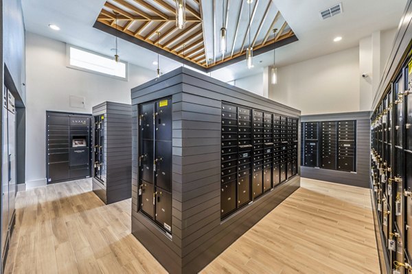 Clubhouse mail room with modern seating and parcel lockers at Lenox Grand West Apartments