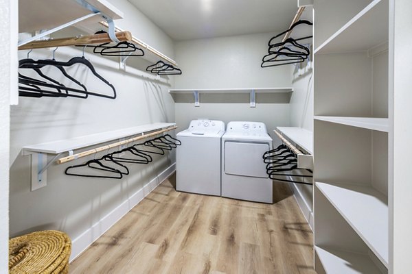 Lenox Grand West Apartments: Laundry room with energy-efficient machines and ample storage space