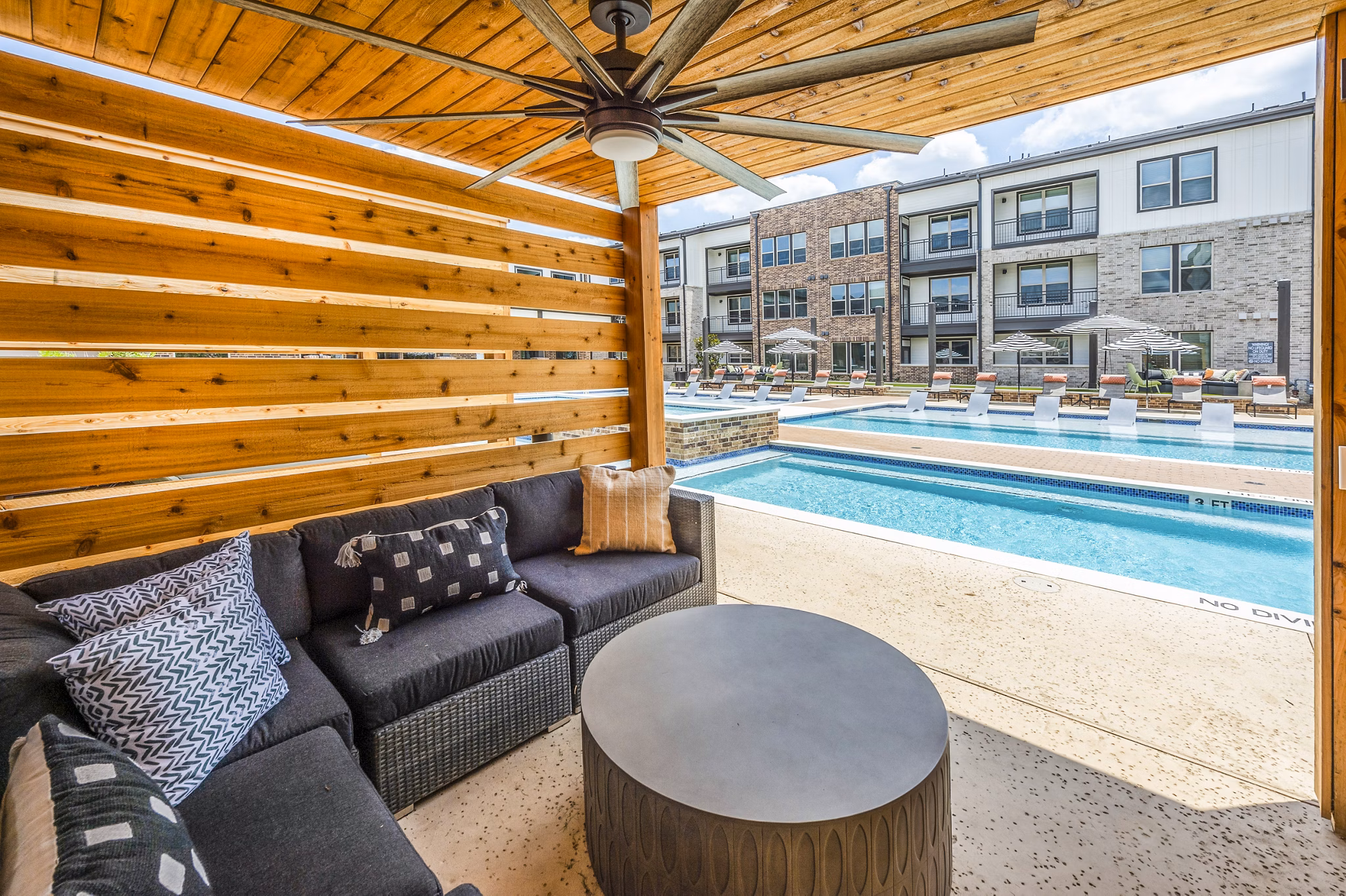 Luxury poolside cabana at Lenox Grand West Apartments with comfortable seating and scenic views