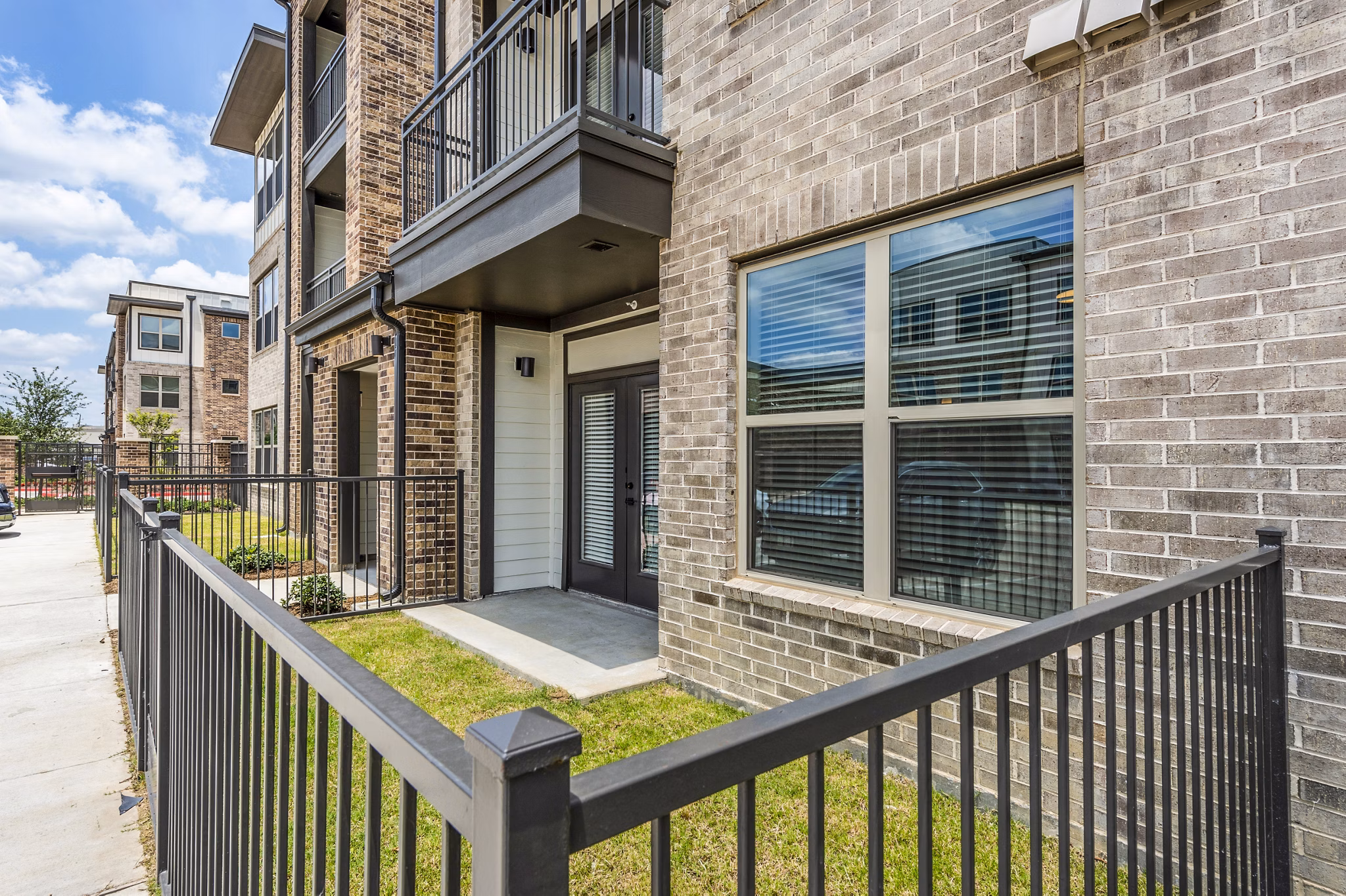 Patio area with cozy seating at Lenox Grand West Apartments, ideal for relaxation in a luxury setting