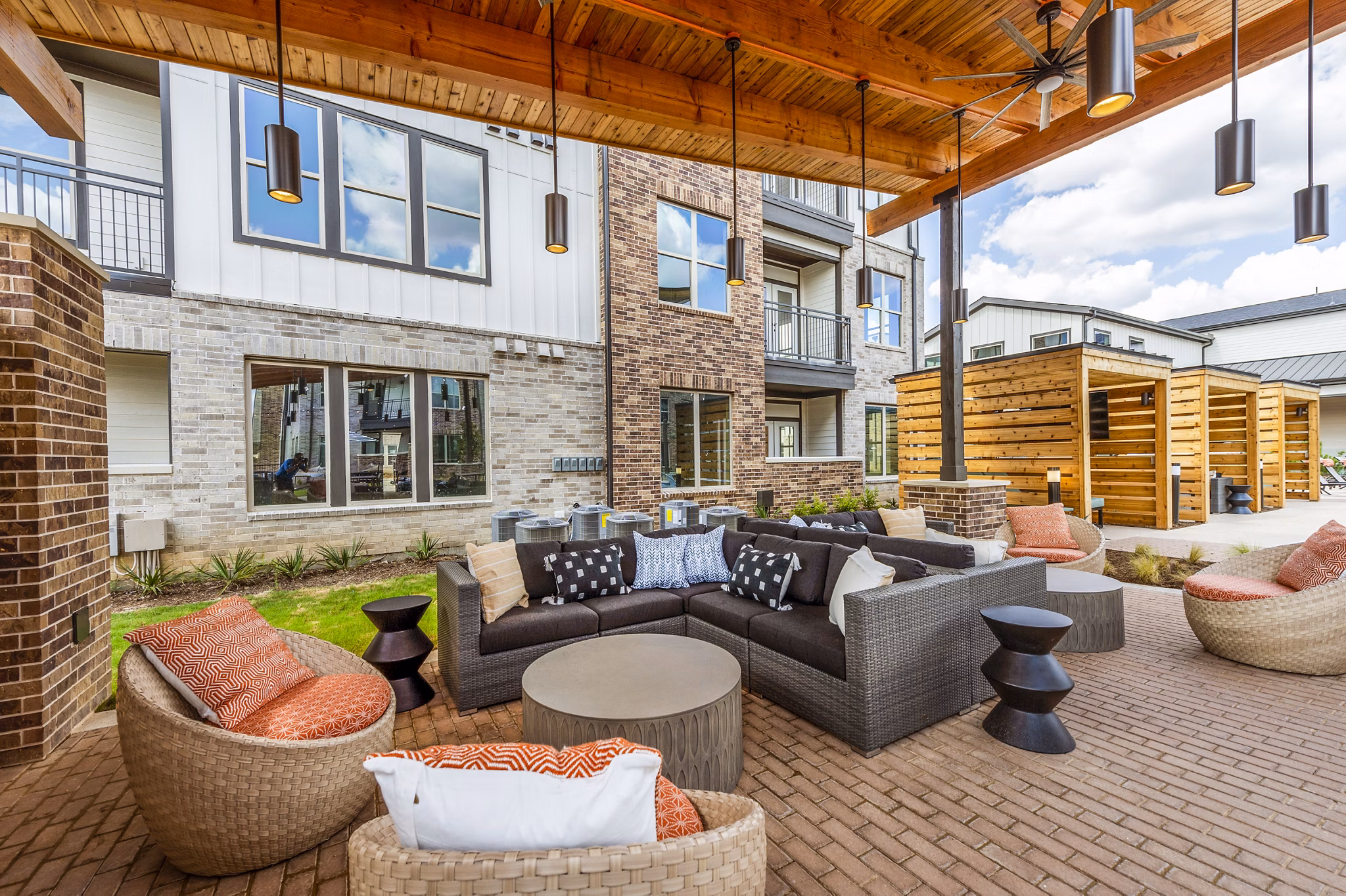 Relaxing pool and patio area with lounge chairs at Lenox Grand West Apartments, ideal for socializing and enjoying the outdoors