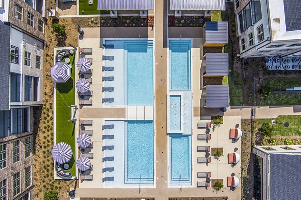 Resort-style pool with sun loungers at Lenox Grand West Apartments