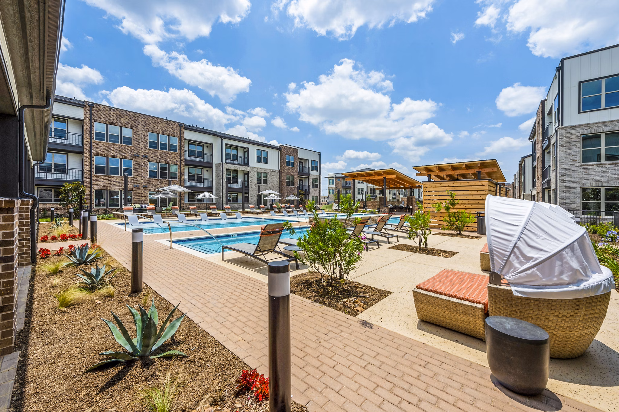 Poolside cabana with lounge seating at Lenox Grand West Apartments