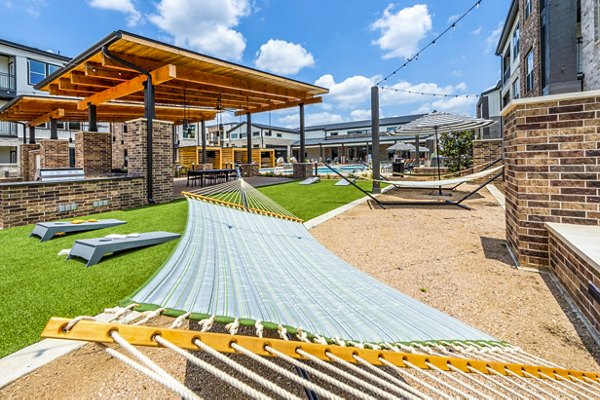 Hammock area with lush greenery at Lenox Grand West Apartments, perfect for relaxation and outdoor leisure activities
