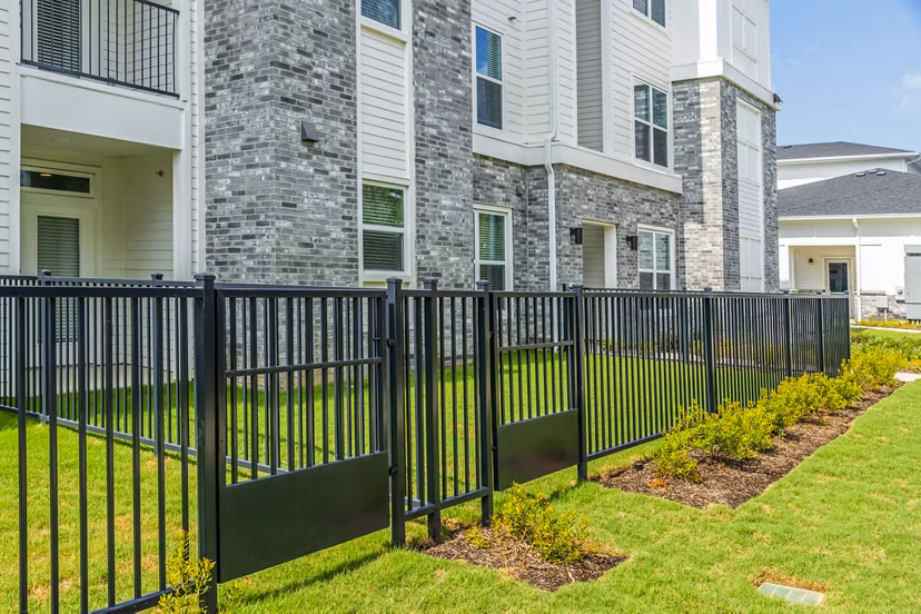 The Madison Apartments: Building with gated backyard showcasing luxury living