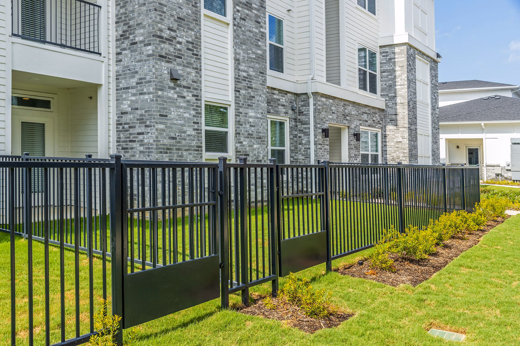The Madison Apartments: Building with gated backyard showcasing luxury living