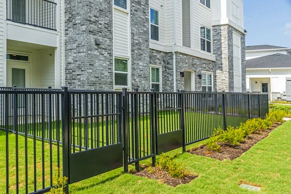 building/exterior with gated backyard at The Madison Apartments