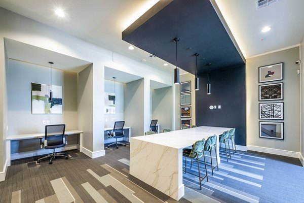 Modern business center with collaborative workspaces at The Madison Apartments clubhouse