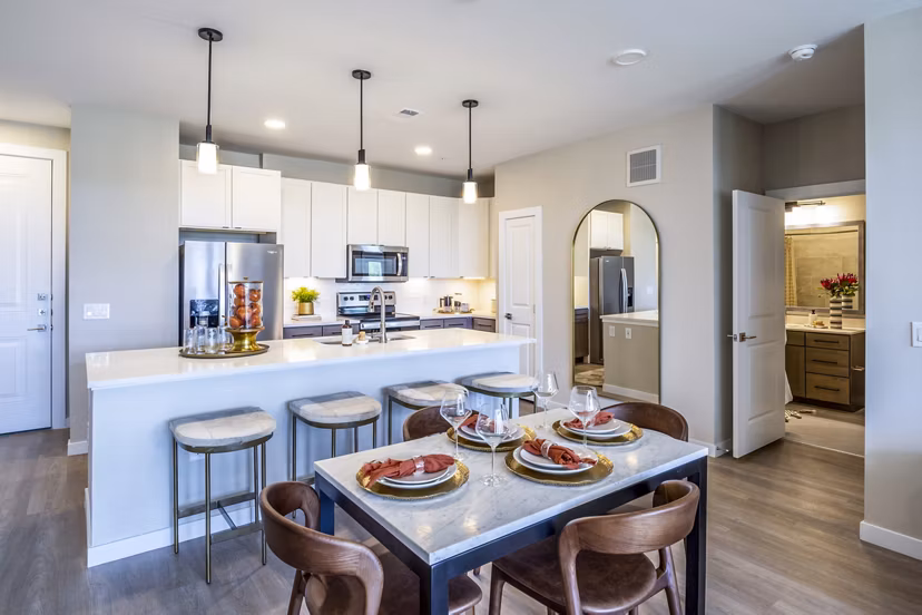 Dining room with elegant chandelier and modern furnishings at The Madison Apartments