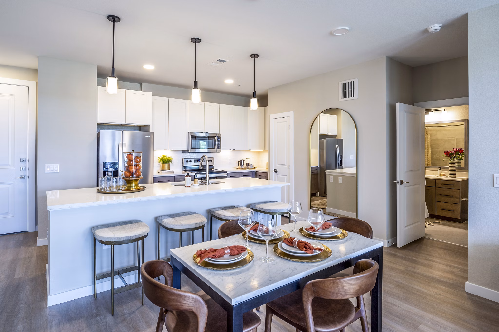 Dining room with elegant chandelier and modern furnishings at The Madison Apartments