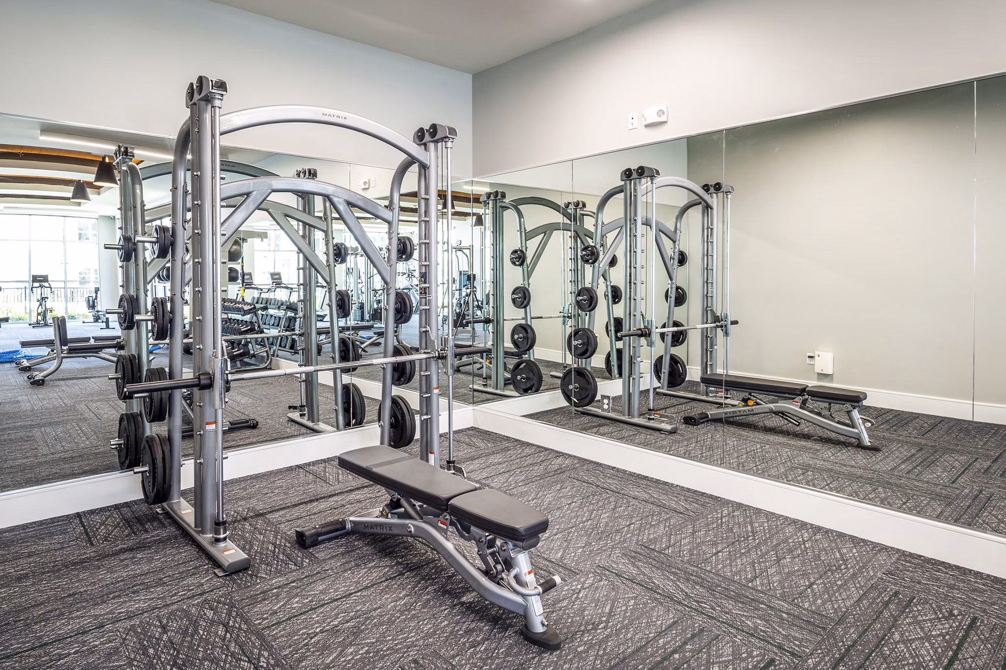 State-of-the-art fitness center at The Madison Apartments with modern equipment, promoting active lifestyles in an upscale community setting