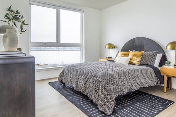 Cozy bedroom with modern decor at Broadstone Claro Apartments, offering luxurious comfort in a stylish setting