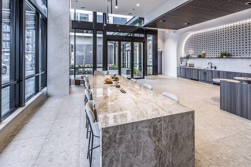 Clubhouse interior featuring modern lounge seating and entertainment options at Broadstone Claro Apartments, a luxury community
