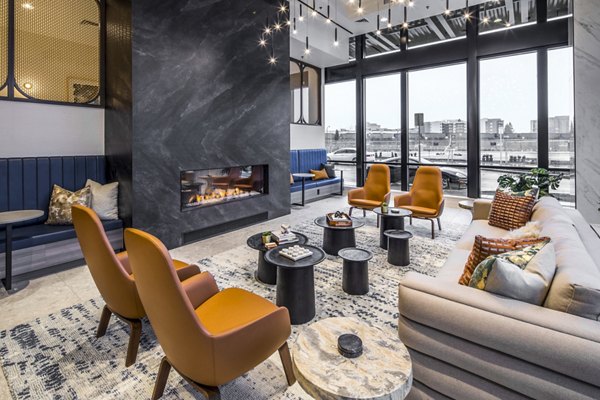 Spacious lobby with modern dÃ©cor in Broadstone Claro Apartments' clubhouse