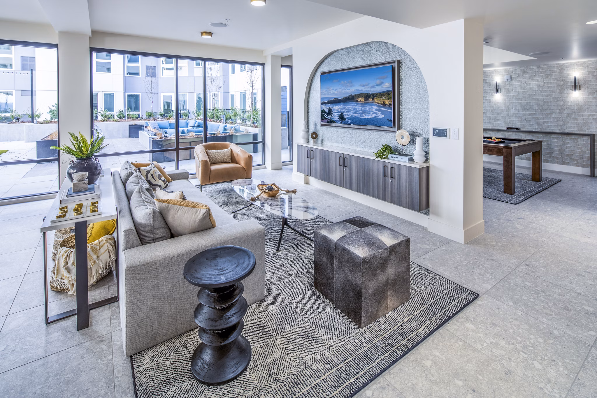 Clubhouse with modern seating and billiards table at Broadstone Claro Apartments