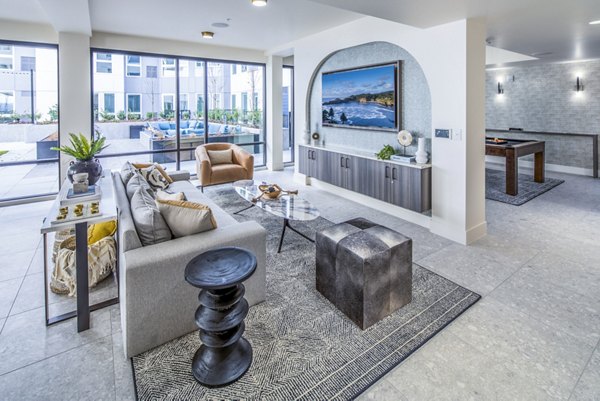 Clubhouse with modern seating and billiards table at Broadstone Claro Apartments