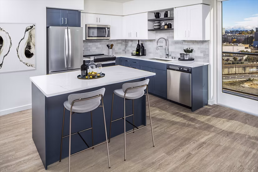 Modern kitchen featuring stainless steel appliances and granite countertops at Broadstone Claro Apartments, luxury living in the heart of the city