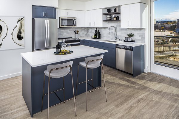 Modern kitchen featuring stainless steel appliances and granite countertops at Broadstone Claro Apartments, luxury living in the heart of the city