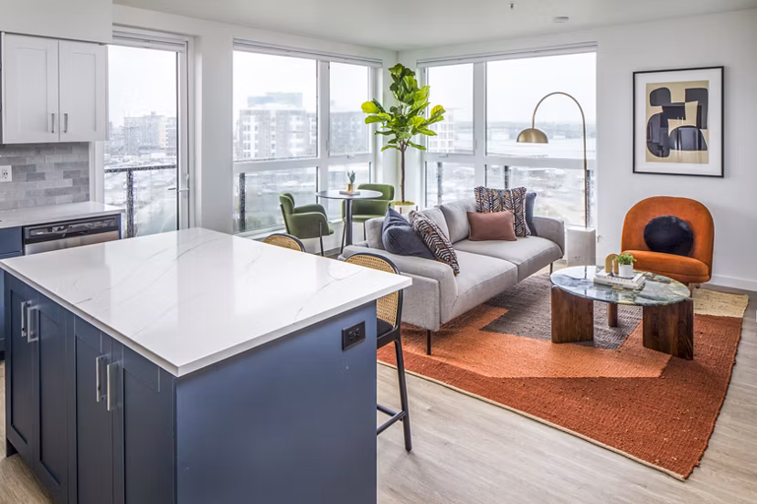Spacious living room featuring modern decor and natural light at Broadstone Claro Apartments