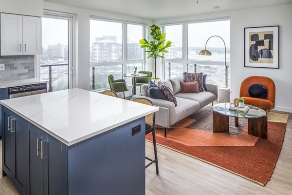 Spacious living room featuring modern decor and natural light at Broadstone Claro Apartments