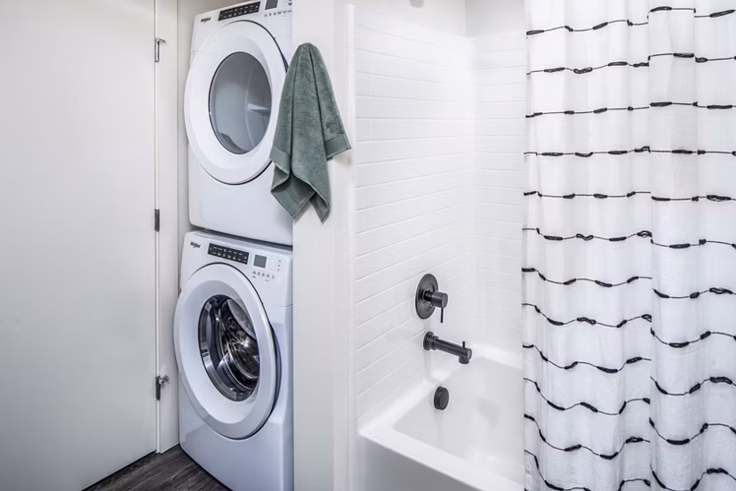 Laundry room featuring modern appliances at Broadstone Claro Apartments, offering convenient washing and drying facilities for residents