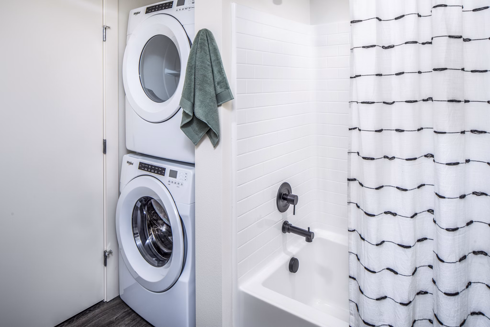 Laundry room featuring modern appliances at Broadstone Claro Apartments, offering convenient washing and drying facilities for residents
