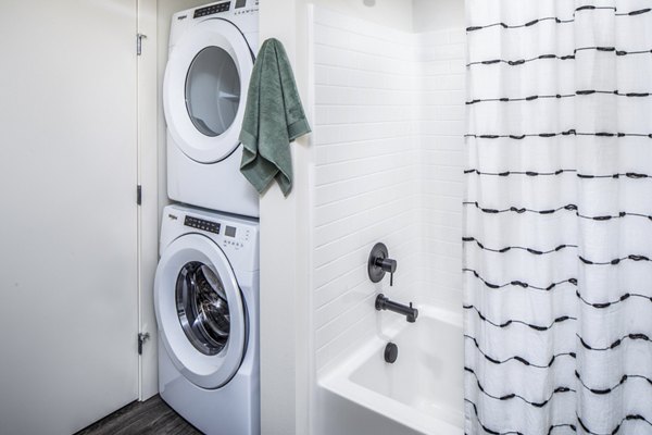Laundry room featuring modern appliances at Broadstone Claro Apartments, offering convenient washing and drying facilities for residents
