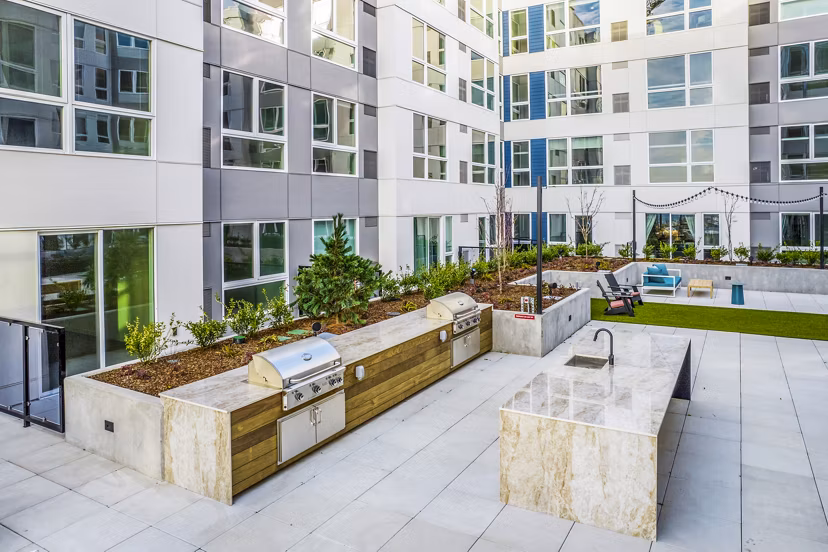 Outdoor patio and grill area at Broadstone Claro Apartments offering luxury outdoor living spaces
