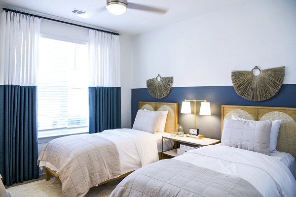 Cozy bedroom with lake views at Lakehouse on Wylie Apartments, blending comfort and luxury in a serene setting