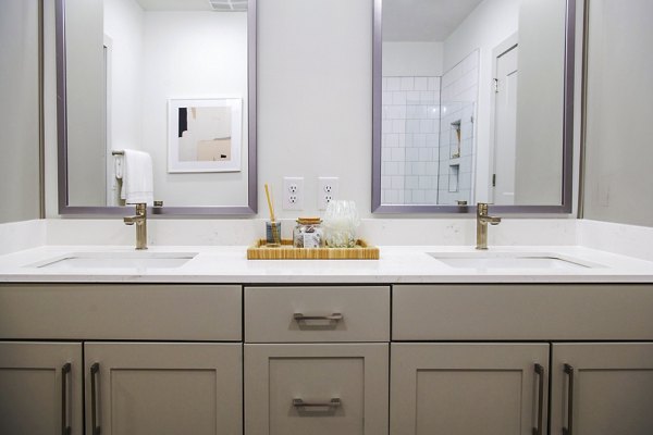 Bathroom featuring elegant fixtures and marble countertops at Lakehouse on Wylie Apartments