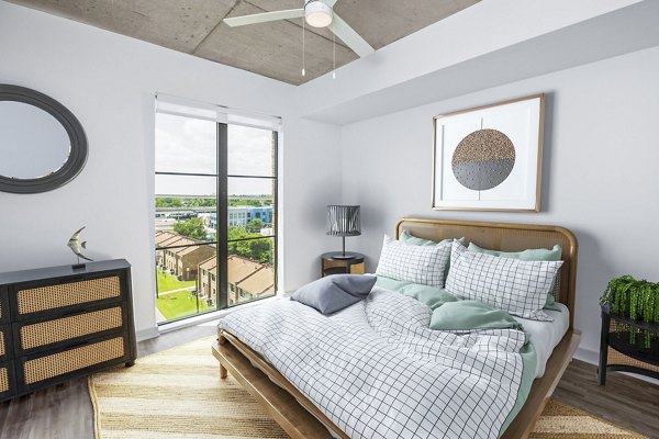 Elegant bedroom with contemporary decor at Atlantic on Romney Apartments in Charleston, showcasing luxury living spaces