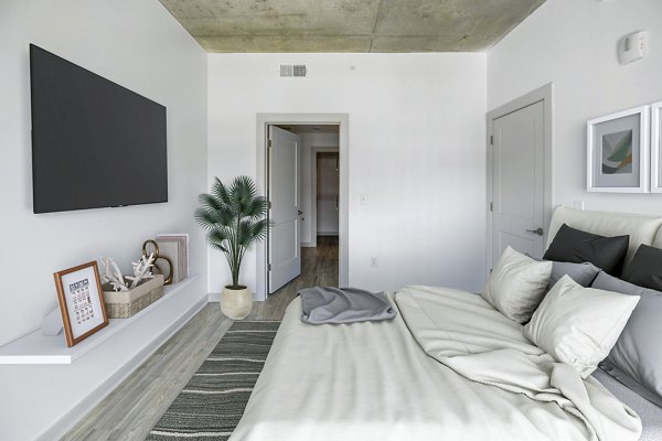 Bedroom with modern decor and ample natural light at Atlantic on Romney Apartments