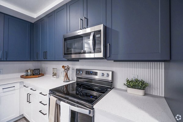 Atlantic on Romney Apartments: Modern kitchen with stainless steel appliances and granite countertops