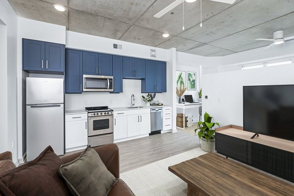 Modern kitchen with stainless steel appliances at Atlantic on Romney Apartments, showcasing luxury features and elegant design