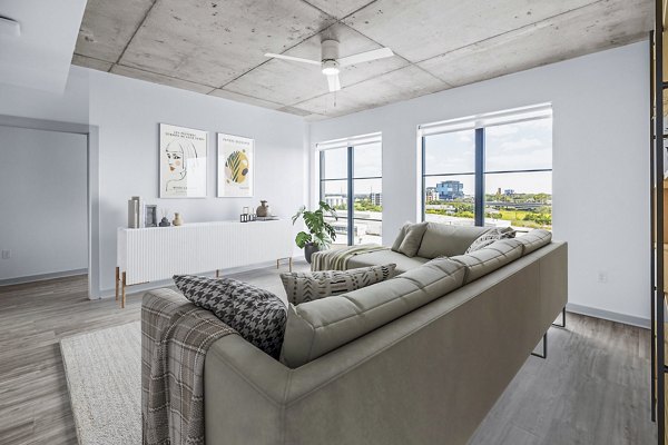 Stylish living room with modern decor and natural light at Atlantic on Romney Apartments