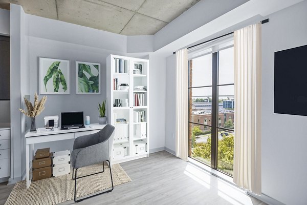 Home office with large desk and ergonomic chair in Atlantic on Romney Apartments