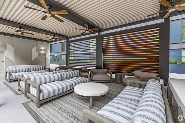 Atlantic on Romney Apartments: Modern pool and patio with comfortable loungers and lush landscaping