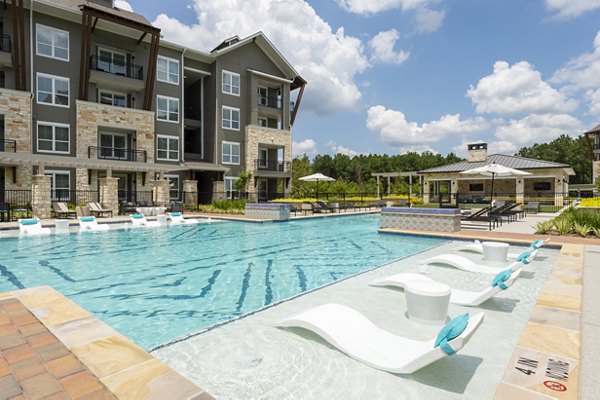 Pool with palm trees at Creekside Park The Grove Apartments, ideal for relaxation and leisure
